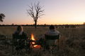 The group gathers around the camp fire each morning to watch the sun rise and prepare for the day with an early breakfast.